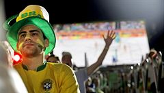 A Brazilian fan watches while a German fan celebrates in the background after...