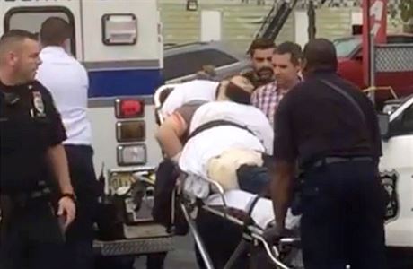 Policemen place in an ambulance a man they identified as Ahmad Khan Rahami in...