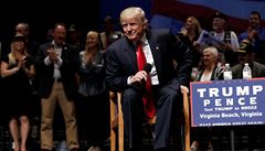 Republican presidential nominee Donald Trump sits on stage during a campaign...