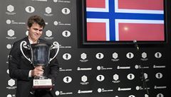 Magnus Carlsen si potkává trofej pro vítze.