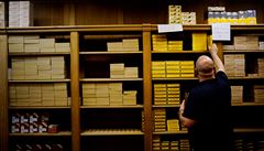 A customer selects cigar boxes at a cigar shop in Havana, Cuba