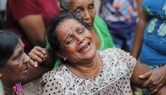 A Sri Lankan woman who lost her family members in a garbage dump collapse cries...