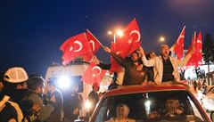 Supporters of Turkish President Tayyip Erdogan wave national flags in Istanbul,