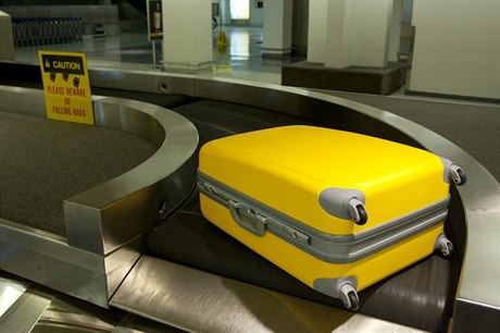 Kufr na letištním pásu. Ilustrační foto.