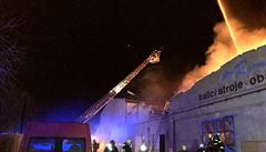 Požár haly ve Vinoři, který si vyžádal nejvyšší stupeň poplachu, je pod kontrolou. Zranil se hasič a policisté