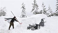 Mu v italském Sestriere odklízí sníh ze svého auta.