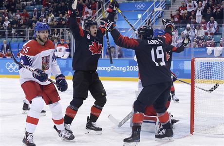 Mason Raymond, second from left, of Canada, celebrates with Andrew Ebbett (19)...