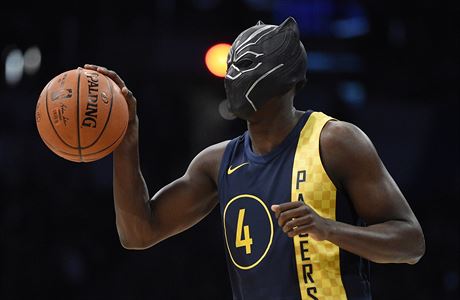 Indiana Pacers' Victor Oladipo gets ready for a dunk while wearing a mask from...