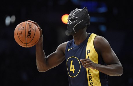 Indiana Pacers' Victor Oladipo gets ready for a dunk while wearing a mask from...