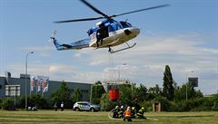 Policejní vrtulník s nádrí s vodou pi poáru v praské Hostivai.