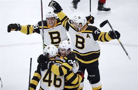 Boston Bruins center David Krejci (46) is congratulated by teammates after his...