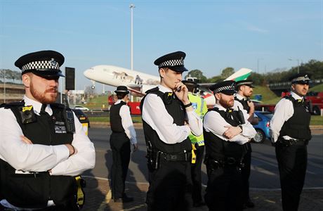 Police officers stand guard during an Extinction Rebellion protest outside...