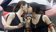 Same-sex marriage supporters kiss outside the Legislative Yuan Friday, May 17,...