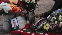 A mourner touches a photograph at the grave of Captain third rank Vladimir...