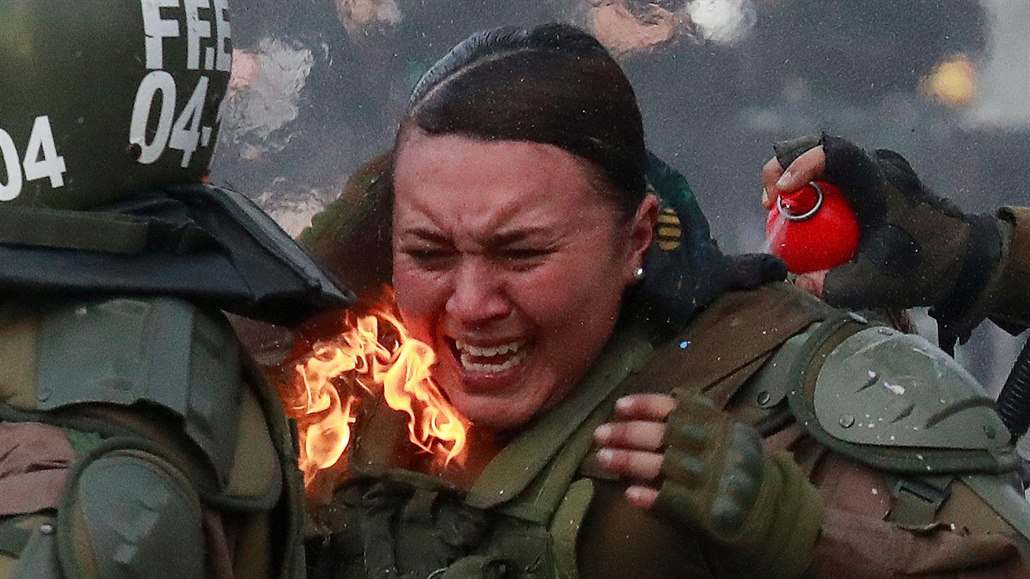 Hořící policistka při zásahu na protestech v Chile