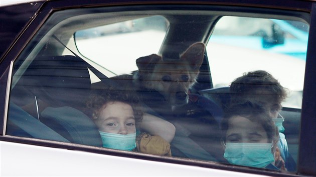 Dti s roukami na ústech koukají pes okno auta v izraelské Haif.