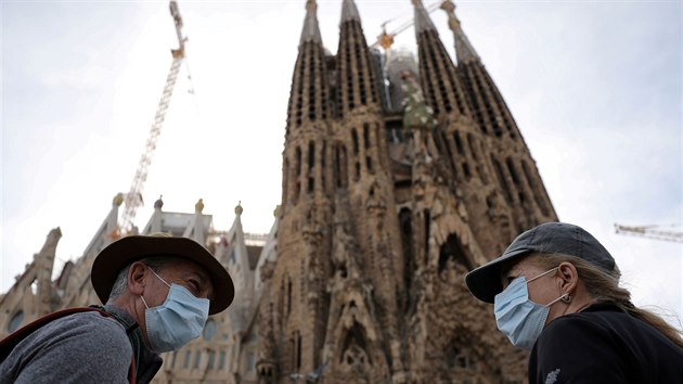 Turisté v Barcelon s roukami na  ústech.