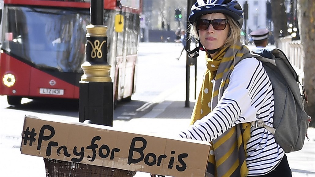 ena s nápisem modleme se za Borise na jejím kole v ulicích Londýna.