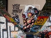 Graffiti obraz mue v sci-fi skafandru s nápisem umývejte si ruce bhem...