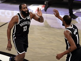 Brooklyn Nets guard James Harden celebrates with forward Kevin Durant (7)...
