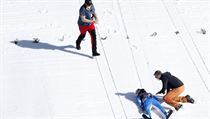Norway's Daniel Andre Tande lies on snow after crashing during the ski flying...