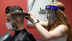 Kadeřnice stříhá 11. května 2020 zákazníkovi vlasy v kadeřnictví Journal v...