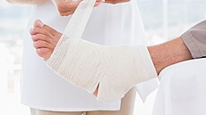 Léka�ka obvazuje nohu pacienta.