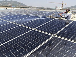 Pracovník istí povrch solárních panel na stee továrny v okrese Zouping ve...