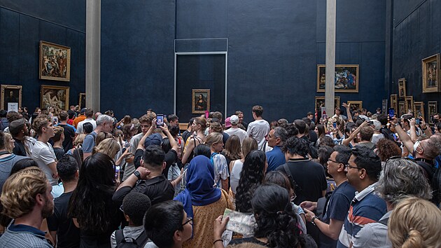 PARIS, FRANCE - AUGUST 22: Visitors take picture of the painting "La Joconde"...